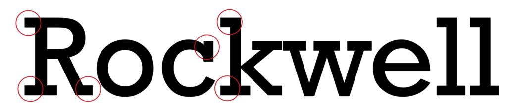 Das Wort „Rockwell“ wird in fetter schwarzer Serifenschrift angezeigt, wobei rote Kreise bestimmte Bereiche hervorheben und wahrscheinlich die Eigenschaften oder Merkmale der Schriftart hervorheben.
